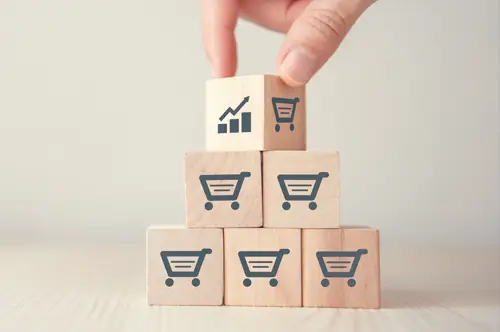 Stack of blocks with money and shopping cart icons